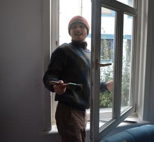Adrian paints a window frame