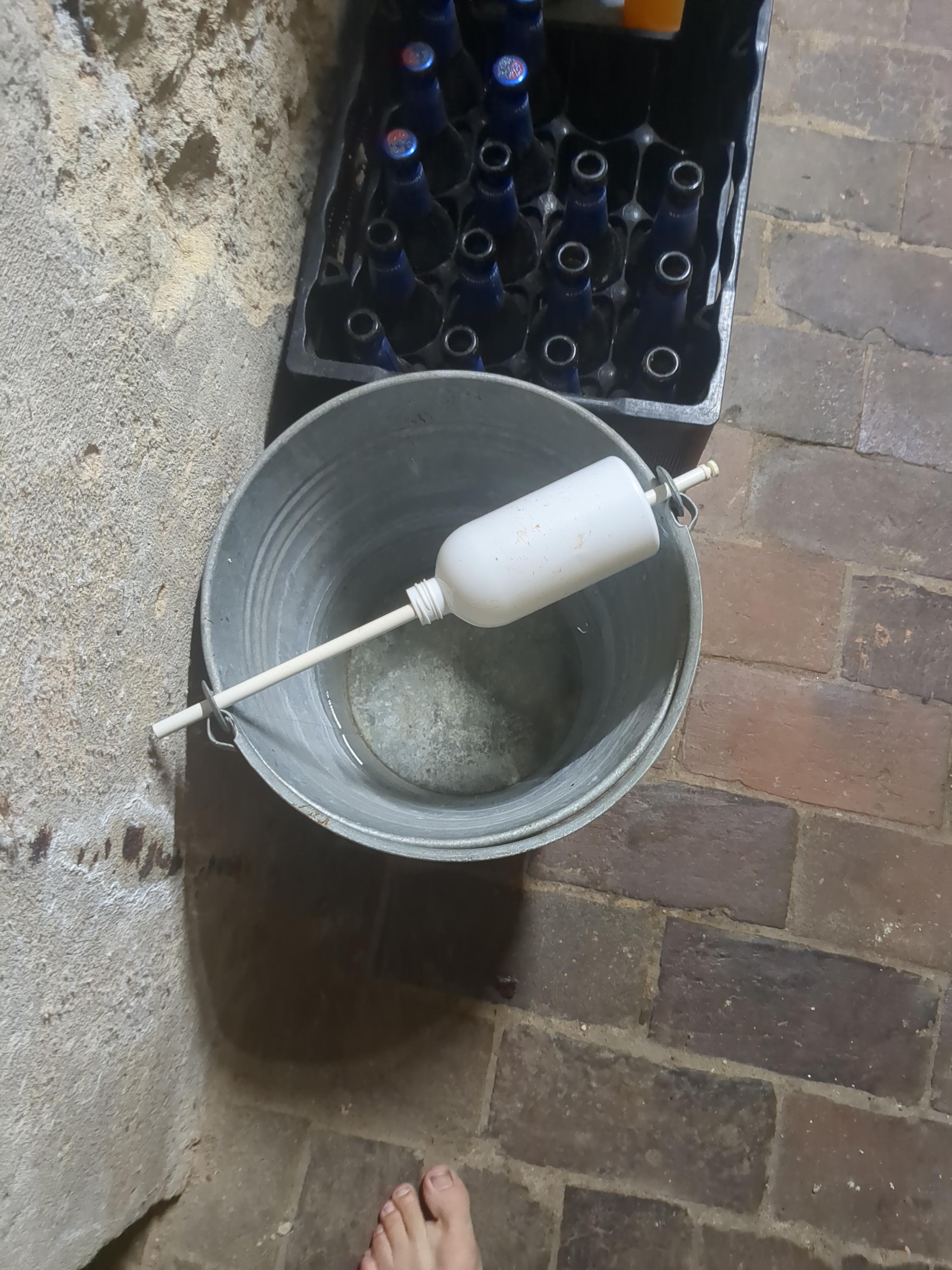 The trap with the bottle pushed to the side on the stick